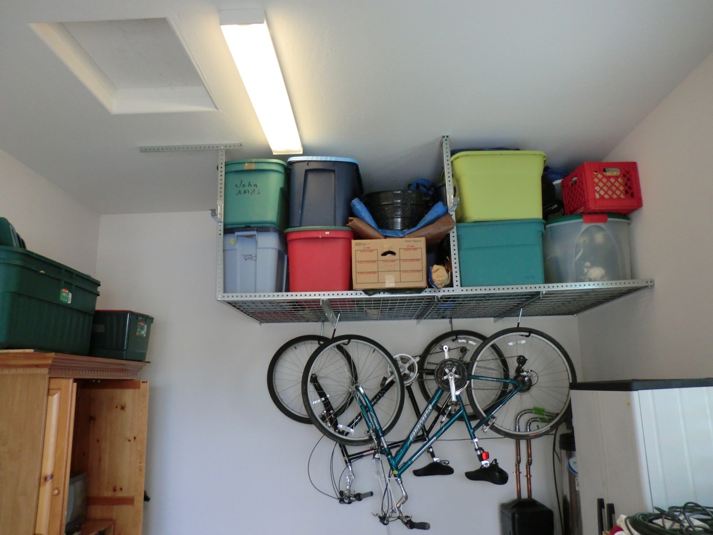 Overhead ceiling rack with four bike hangers