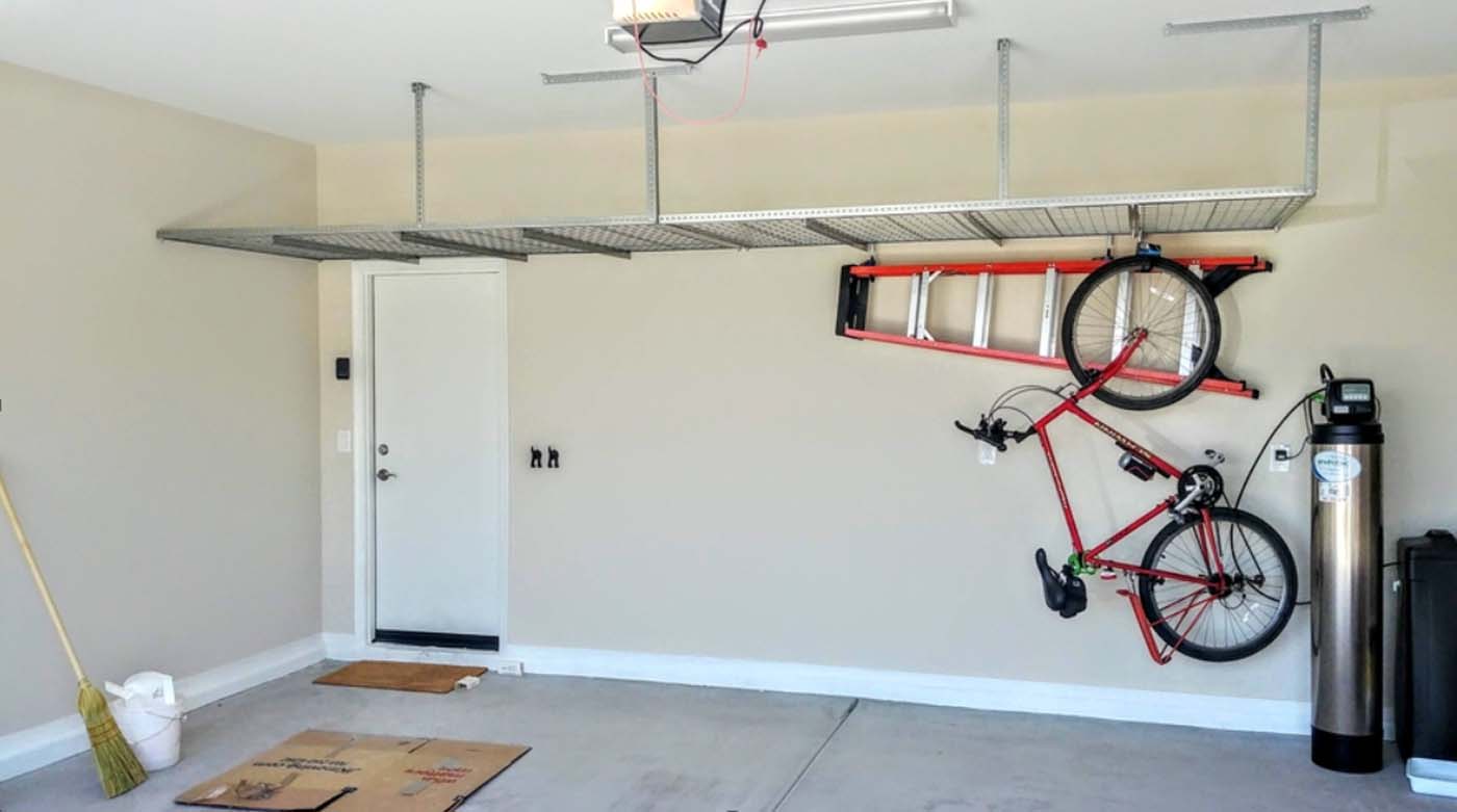 Three overhead storage racks above garage door