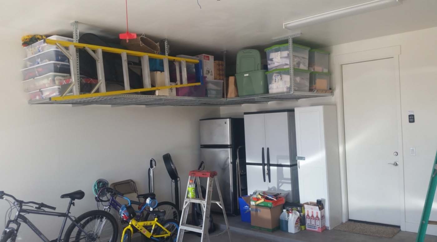 Two ceiling racks with ladder hangers for tools